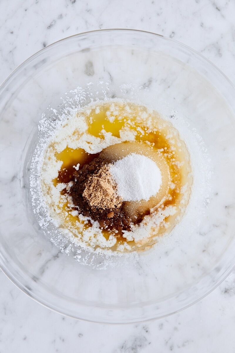 Melted butter, light brown sugar, granulated sugar, and vanilla extract in large glass bowl