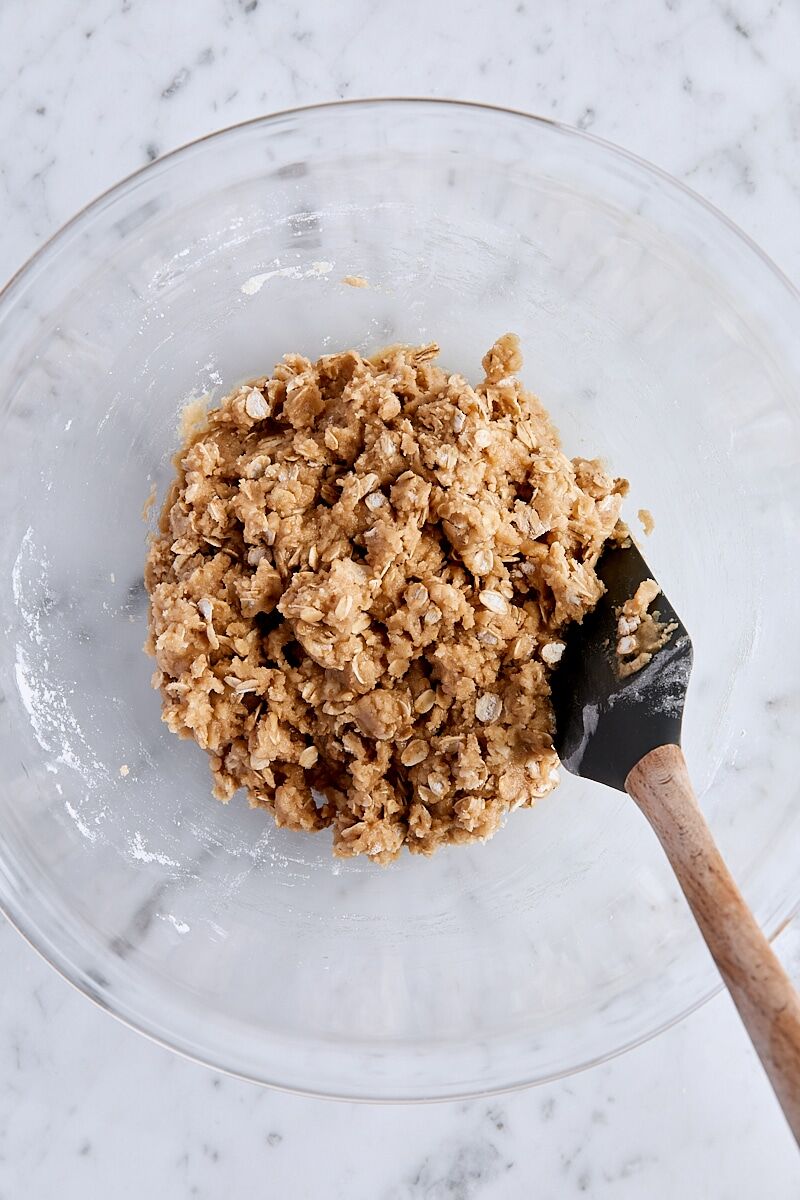 Crust and crumble dough mixed together in large glass bowl with spatula