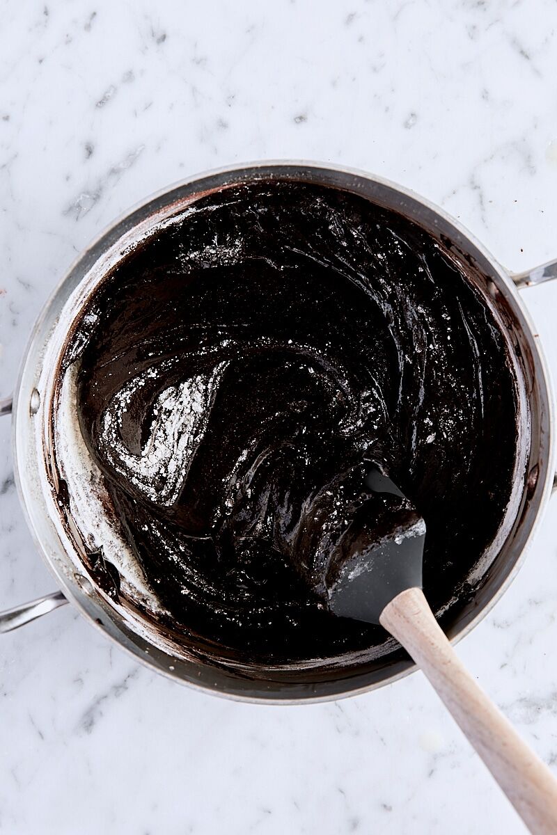 Flour folded into brownie batter with a spatula