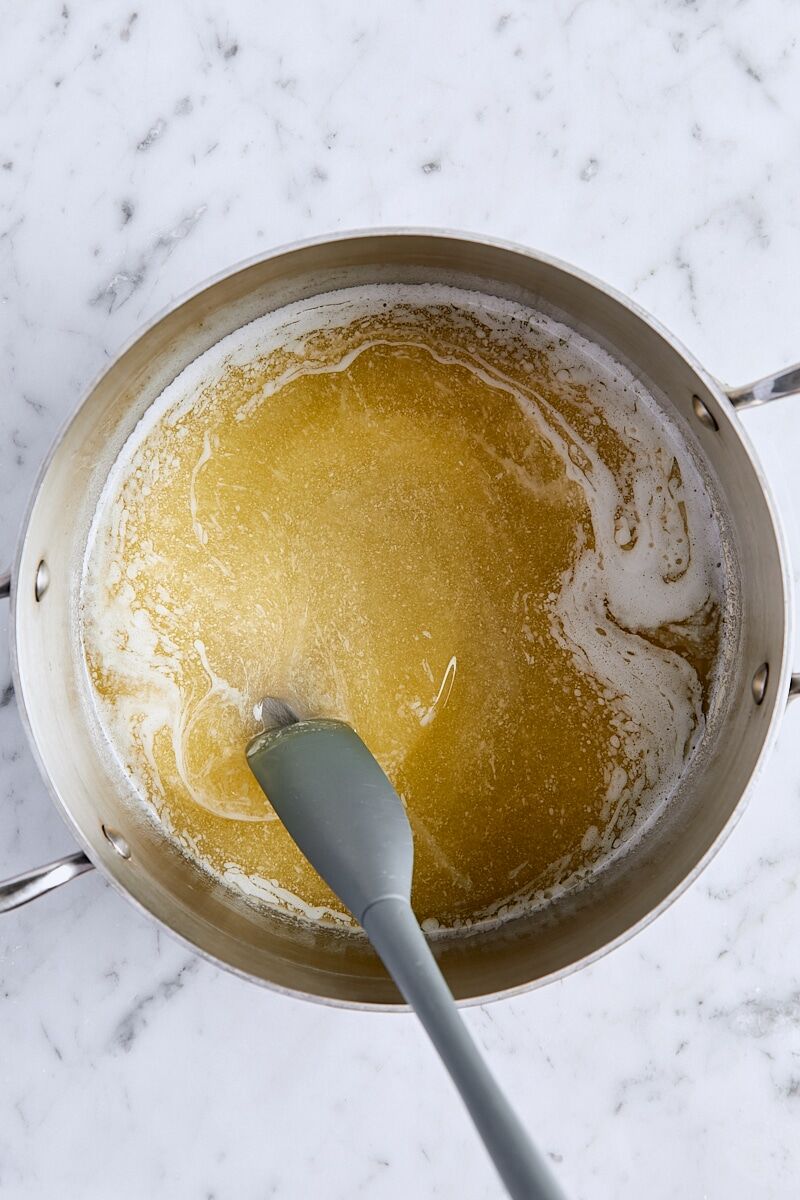 Melted butter in saucepan with small spatula
