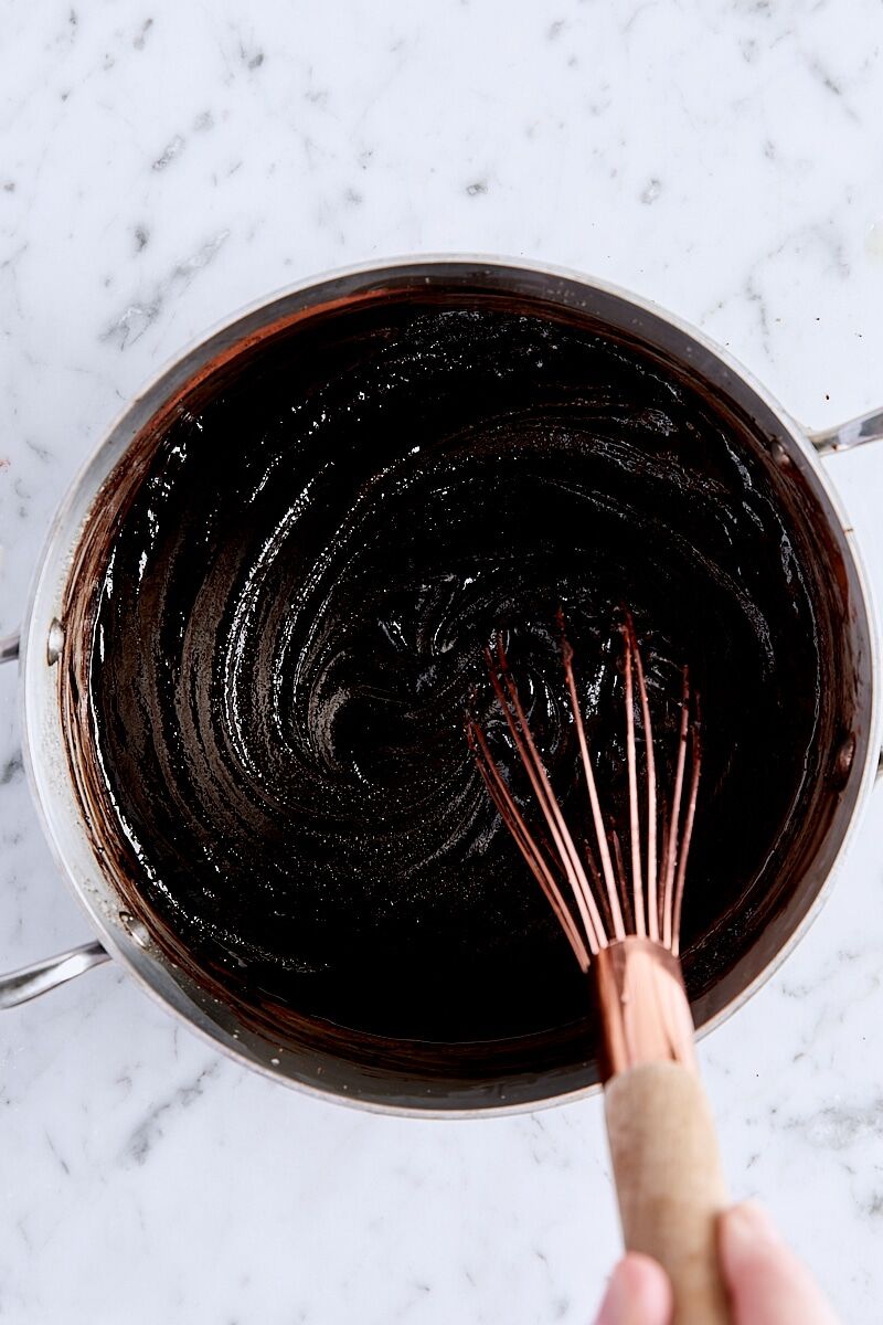 Egg, egg yolk, and vanilla extract whisked into brownie batter