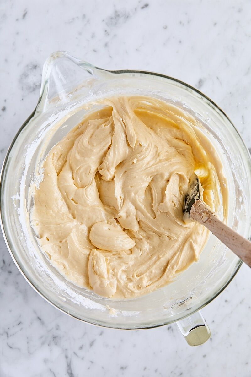 Mixed batter in glass mixer bowl with spatula