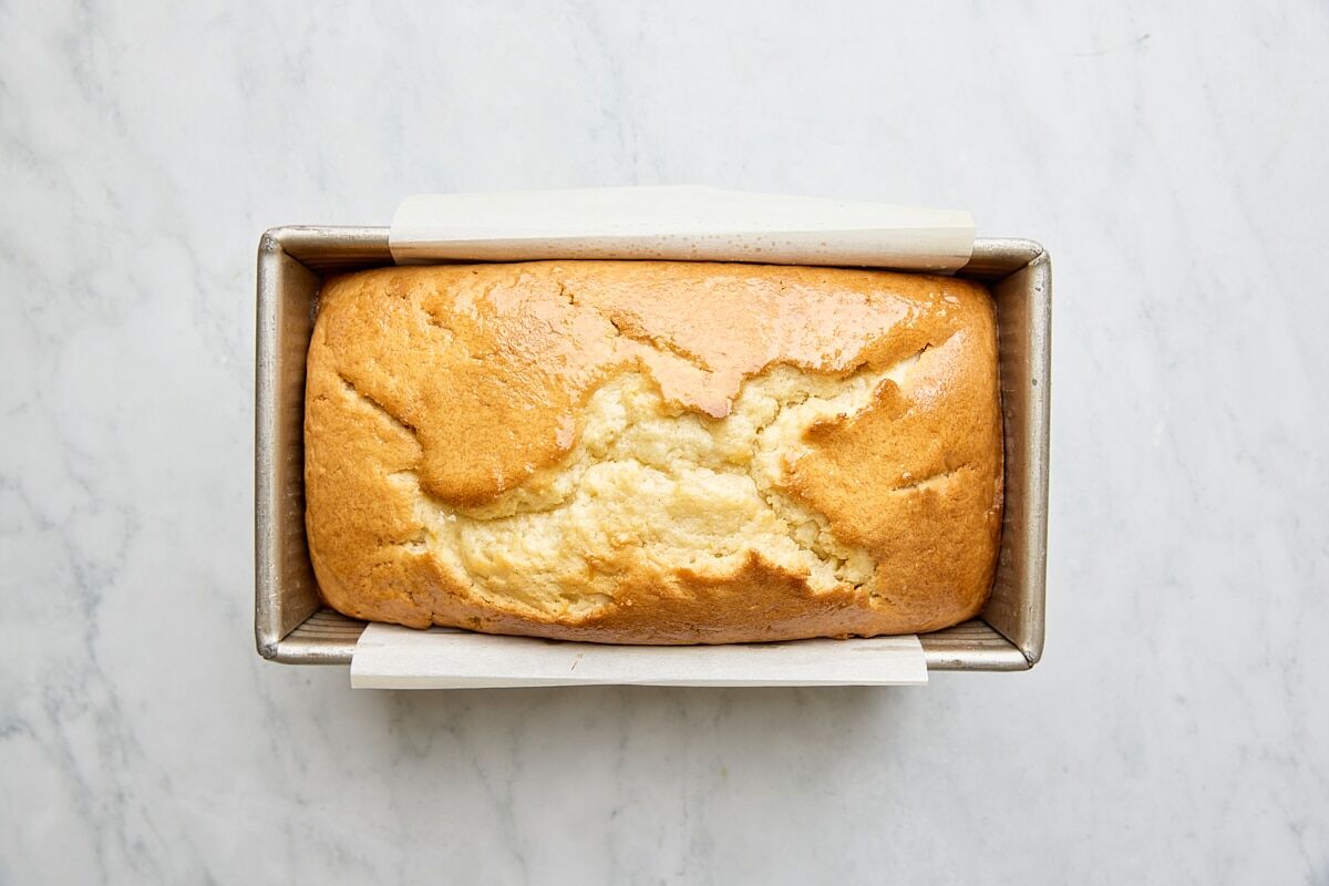 Baked lemon loaf cake in parchment-lined loaf pan
