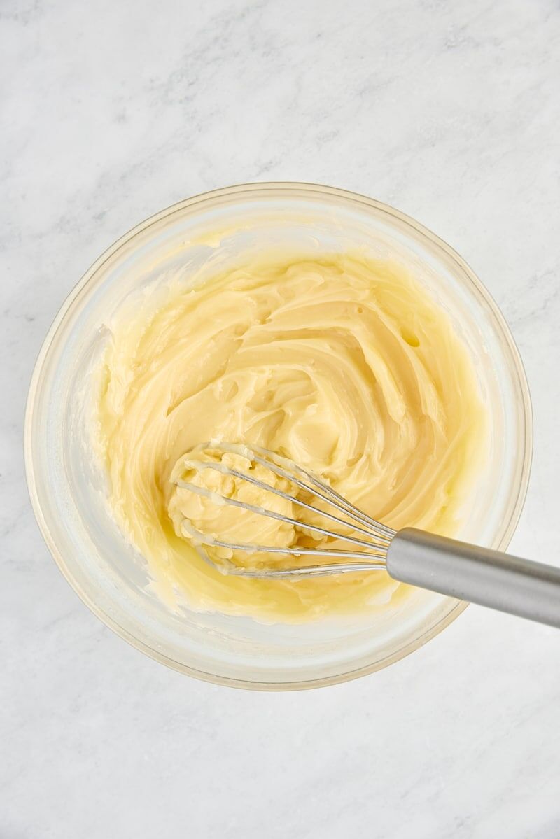 Whipped honey butter in bowl with whisk
