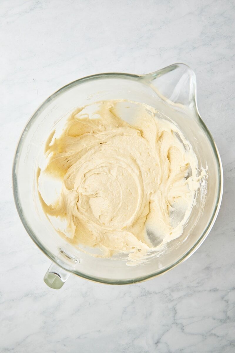 Mixed cake batter in glass mixer bowl