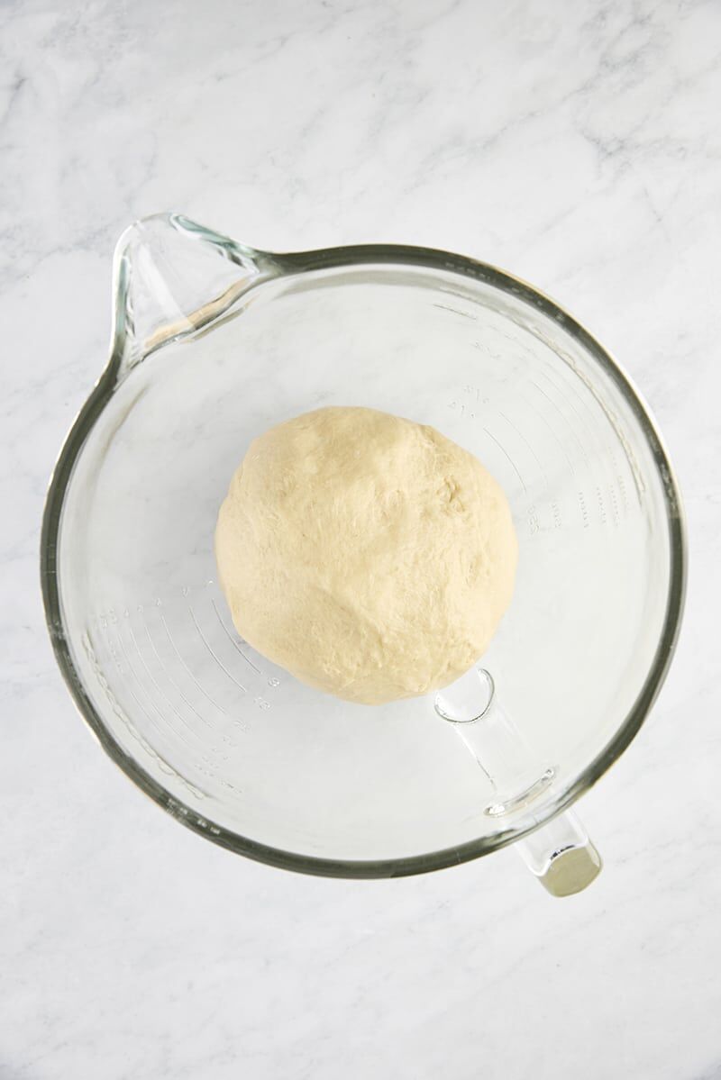 Dough before rise in glass mixer bowl
