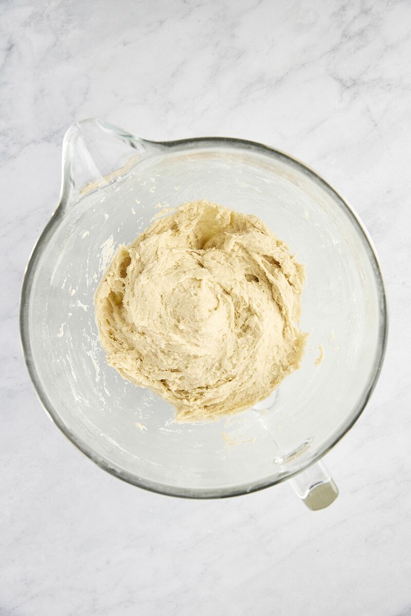 Soft yeast dough in glass mixer bowl