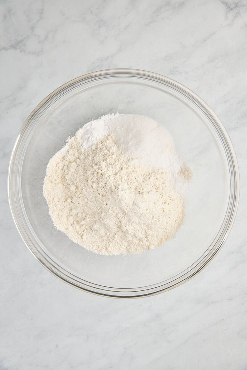 Flour, granulated sugar, baking powder, baking soda, and salt in glass bowl