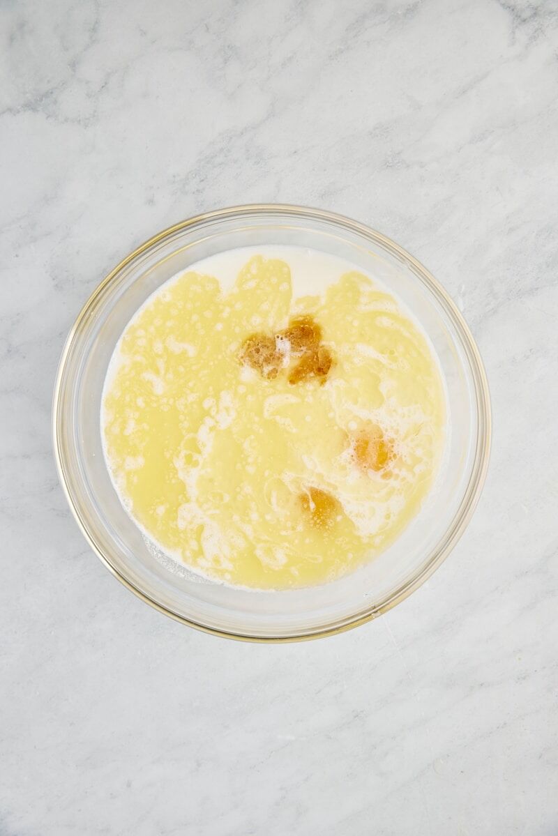 Buttermilk, eggs, melted butter, and vanilla in glass bowl
