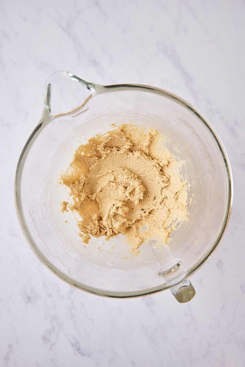 Butter and sugars mixed until soft and creamy in glass mixing bowl