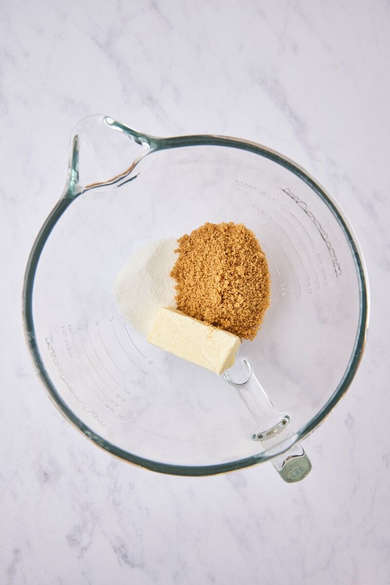 Butter, sugar, and brown sugar in glass mixer bowl