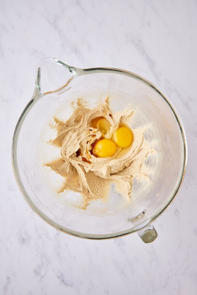 Egg, egg yolk, and vanilla added to mixer bowl