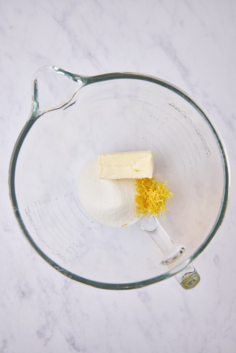 Butter, sugar, and lemon zest in glass mixer bowl