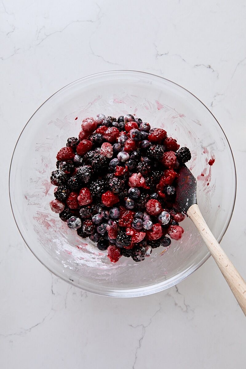 Mixed berry filling in glass bowl with spatula