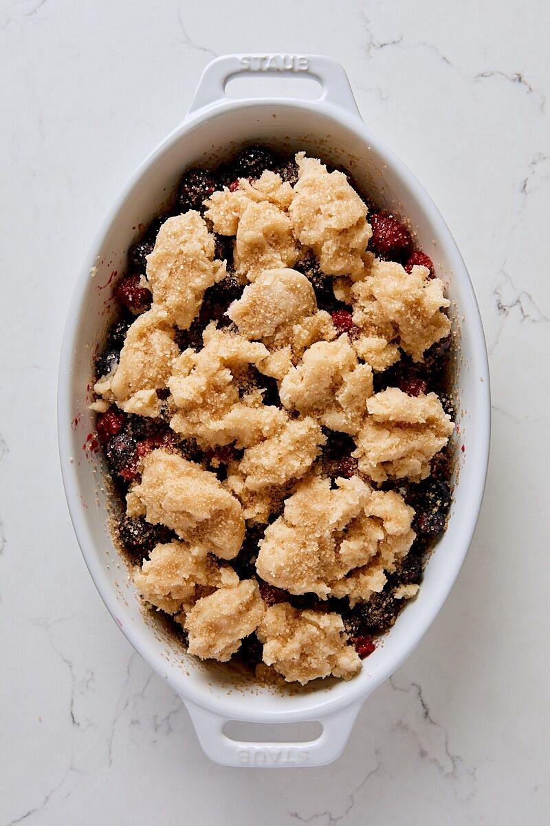 Assembled berry cobbler in baking dish