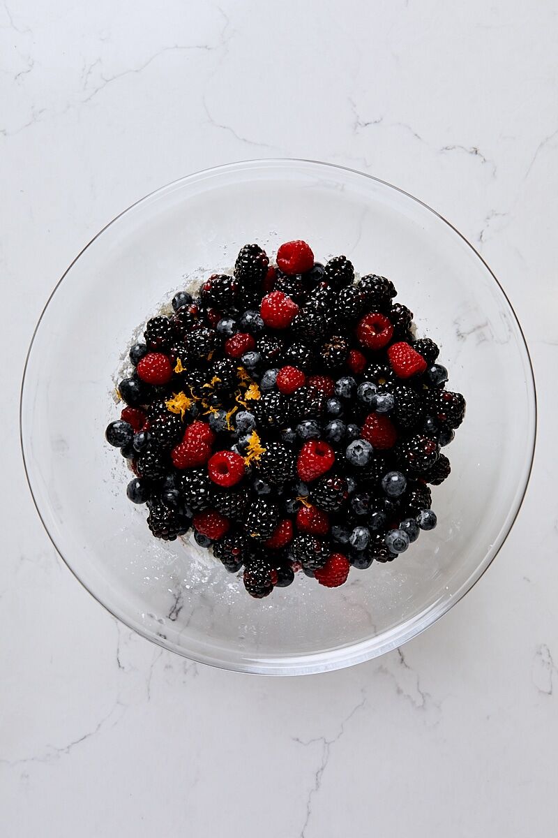 Mixed berries, lemon zest, and lemon juice added to sugar mixture