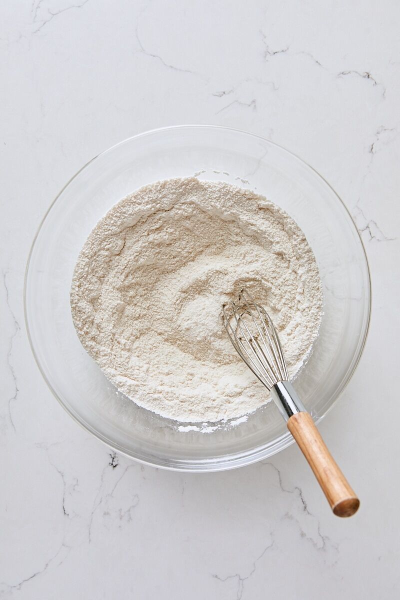 Flour, granulated sugar, baking powder, and salt whisked together in glass bowl