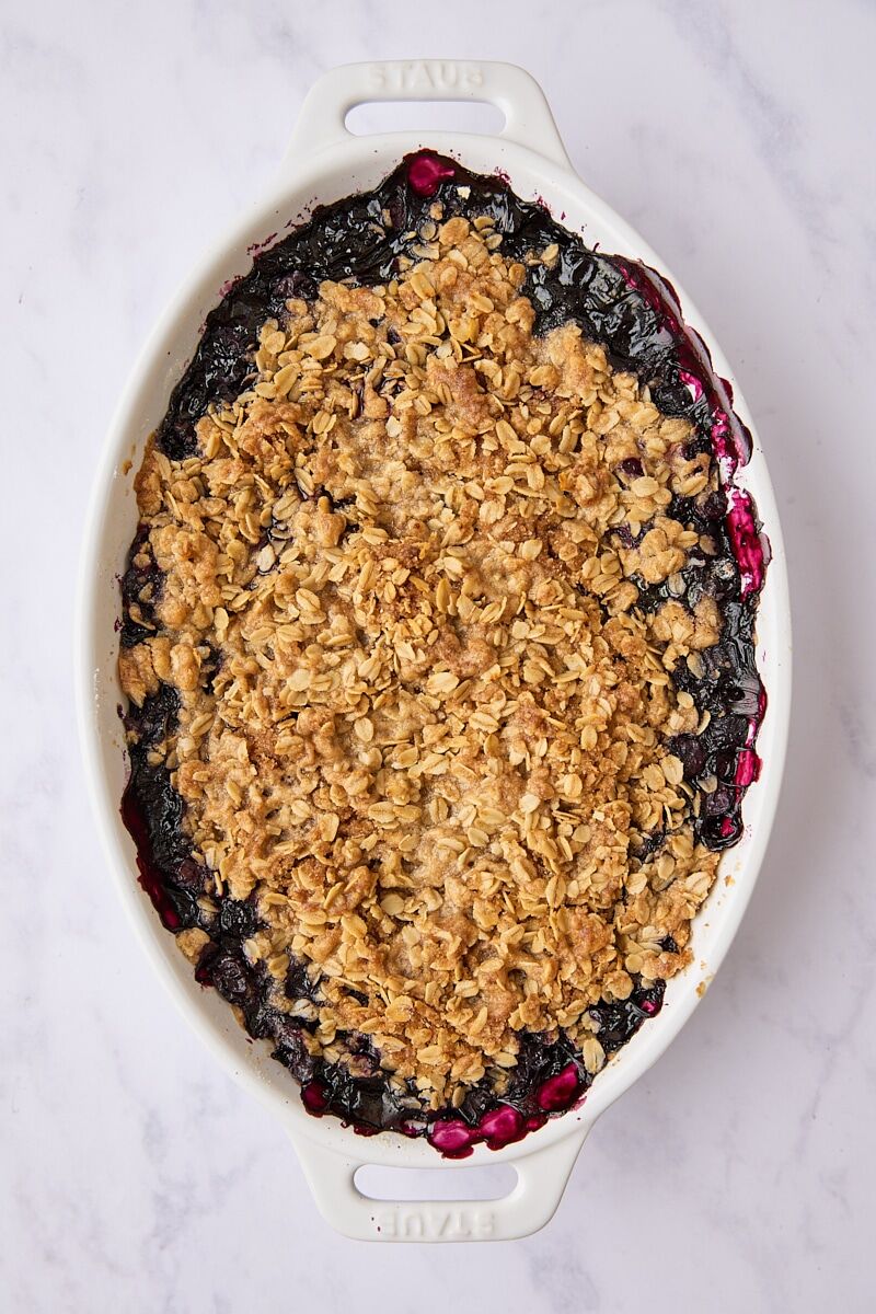 Baked blueberry crisp in white baking dish