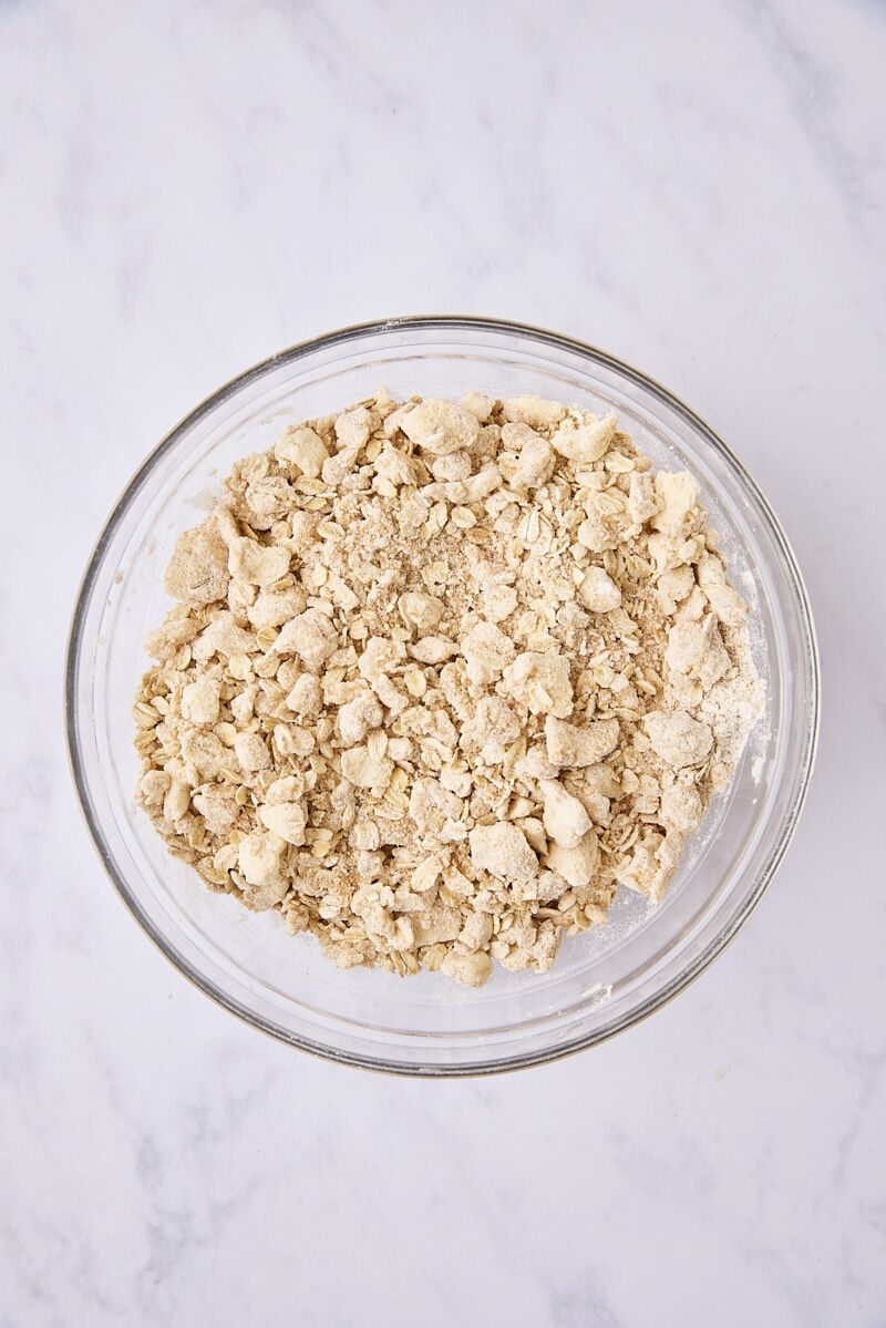 Mixed oatmeal crumble topping in glass bowl