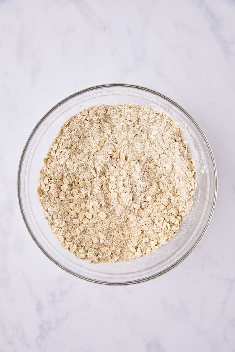 Rolled oats, flour, brown sugar, cinnamon, and salt mixed together in glass bowl