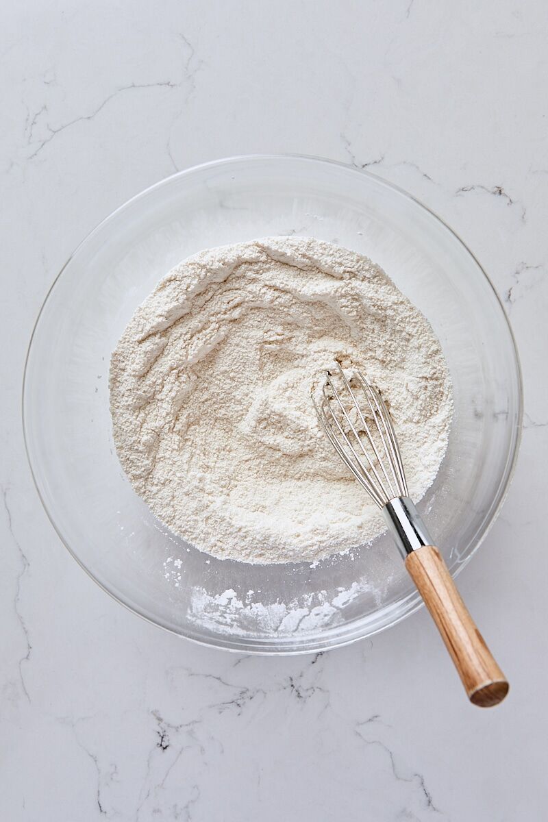 Flour, granulated sugar, baking powder, and salt whisked together in glass bowl