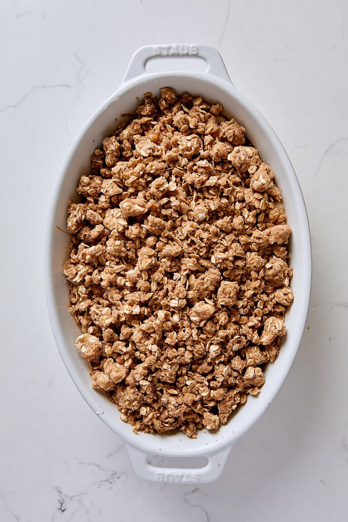Assembled pear crisp in baking dish