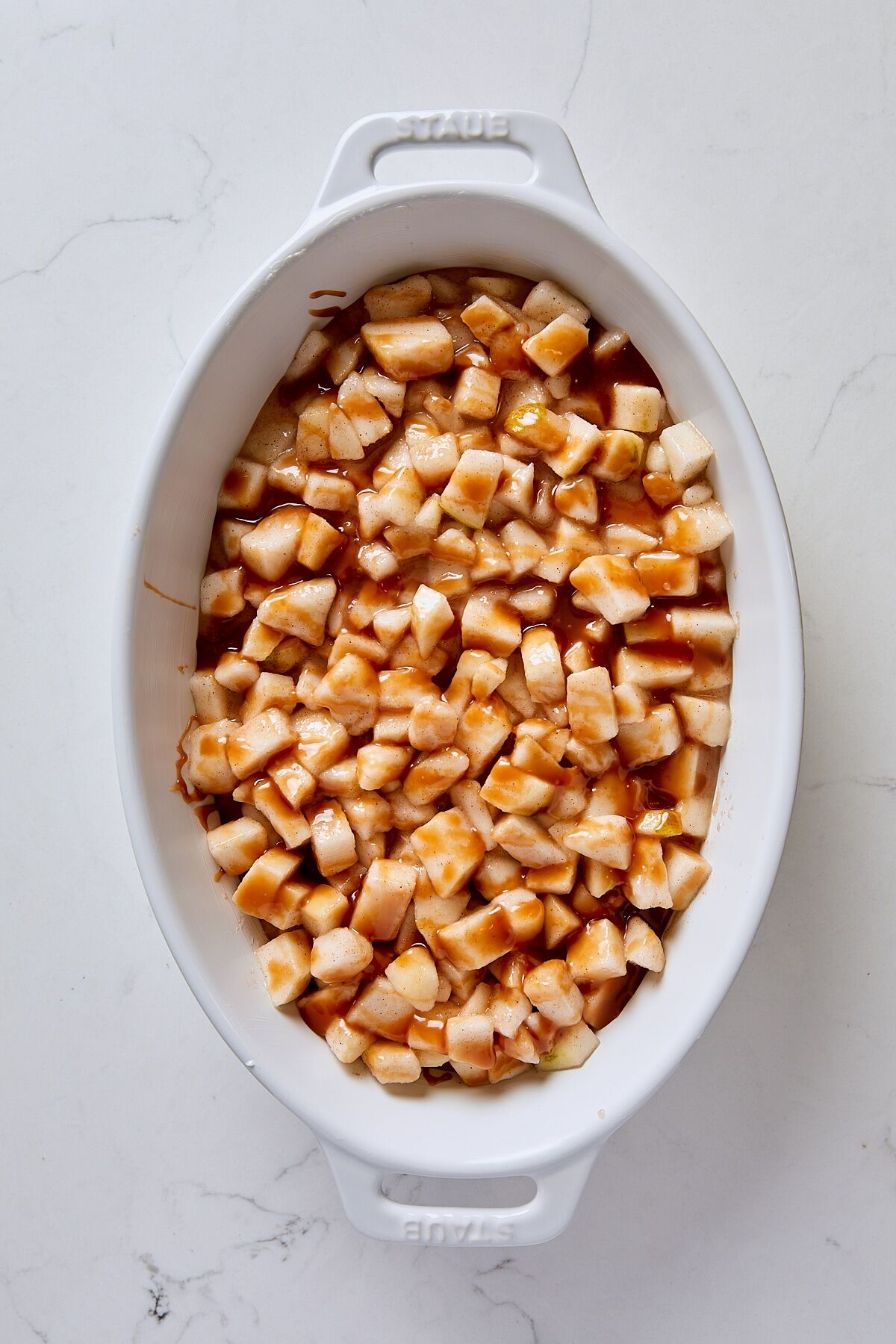 Pear filling spooned into baking dish and drizzled with caramel sauce