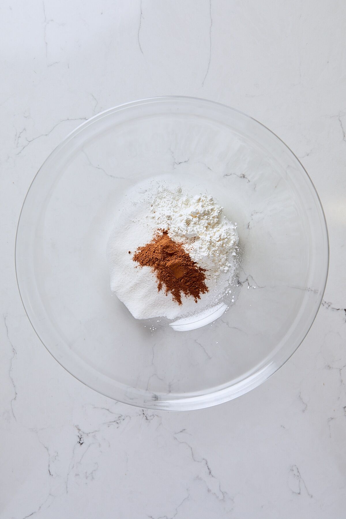 Granulated sugar, arrowroot starch, cinnamon, and salt in large glass bowl