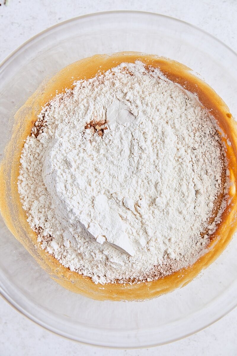 Dry ingredients added to biscotti dough in glass bowl