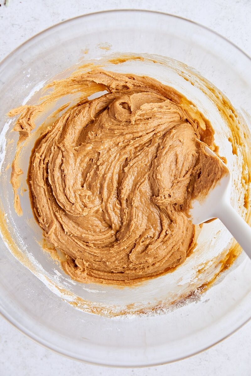 Gingerbread biscotti dough in glass bowl with spatula