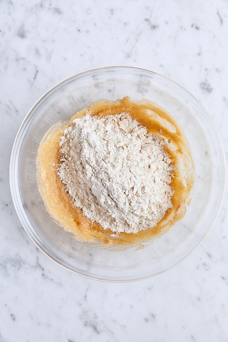 Dry ingredients added to dough in glass bowl