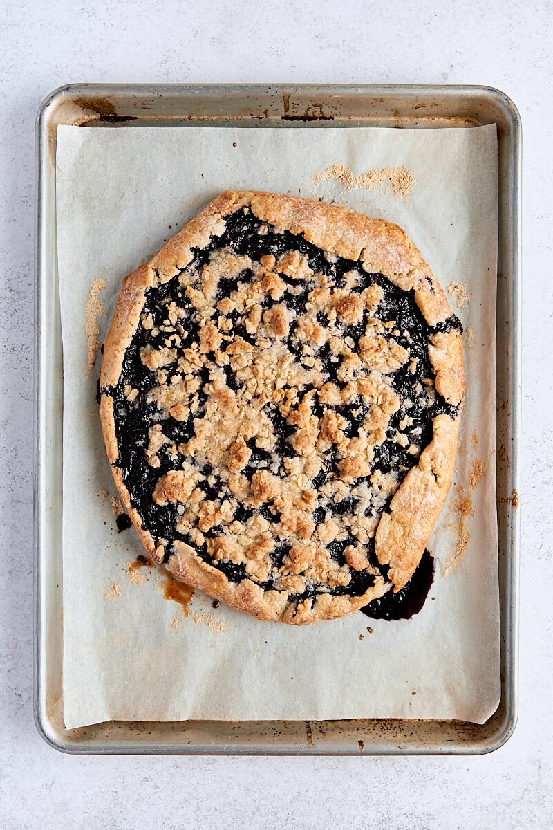 Baked blueberry galette on parchment-lined baking sheet