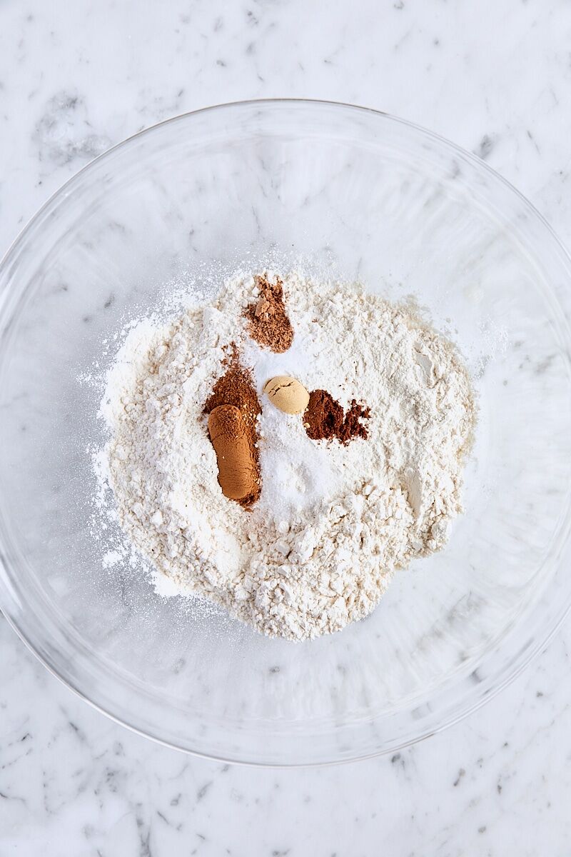 All-purpose flour, baking powder, baking soda, salt, and spices in large glass bowl