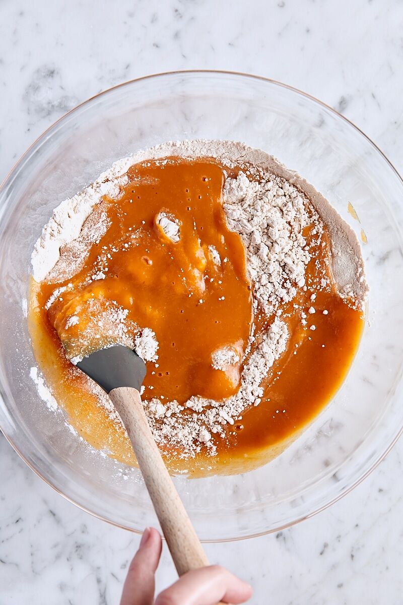 Folding pumpkin mixture into flour mixture with a rubber spatula