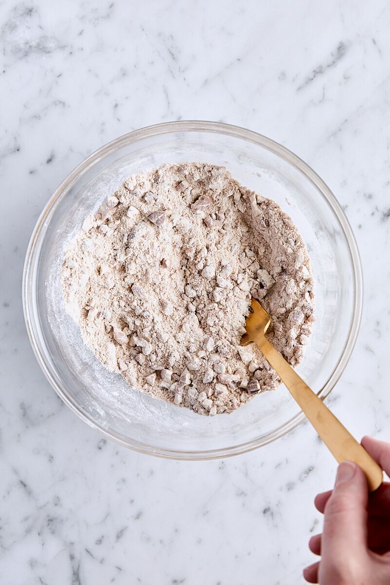 Granulated sugar, brown sugar, spices, all-purpose flour, and chopped pecans whisked together in glass bowl