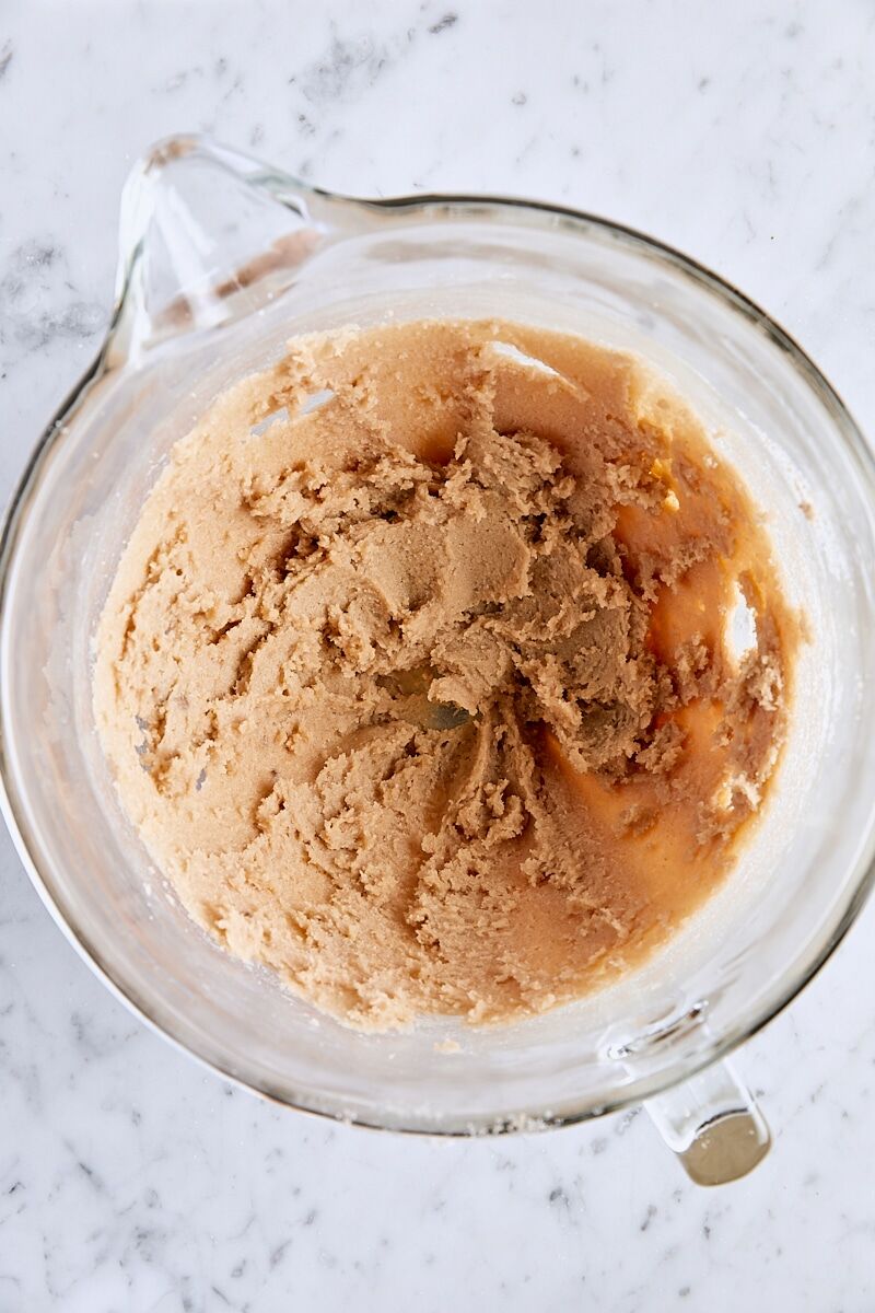 Butter and sugars mixed until soft and creamy in glass mixing bowl