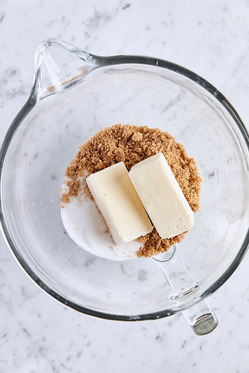 Unsalted butter, dark brown sugar, and granulated sugar in glass mixing bowl
