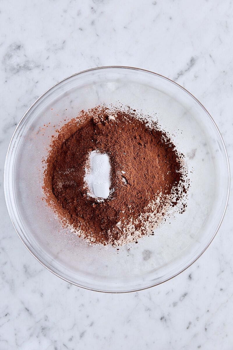Flour, Dutch process unsweetened cocoa powder, baking powder, and salt in glass bowl