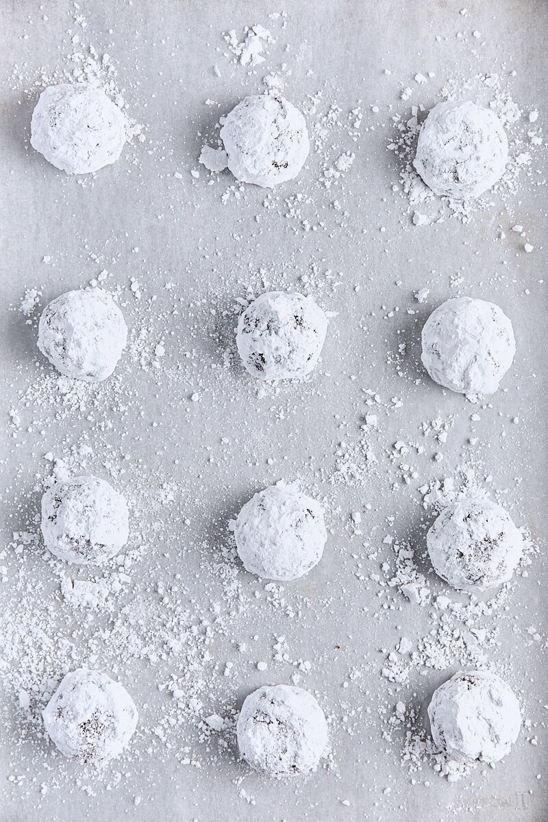 Chocolate cookie dough rolled into balls and coated in powdered sugar