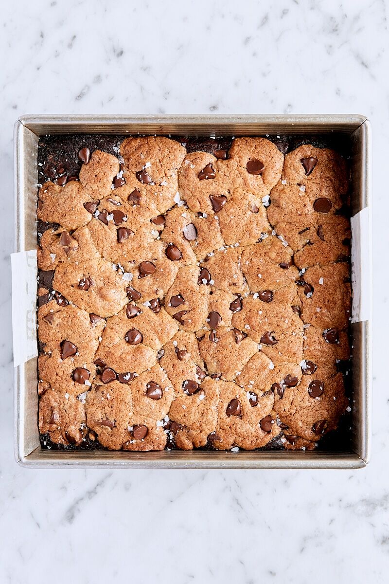 Baked brookies in parchment-lined square pan