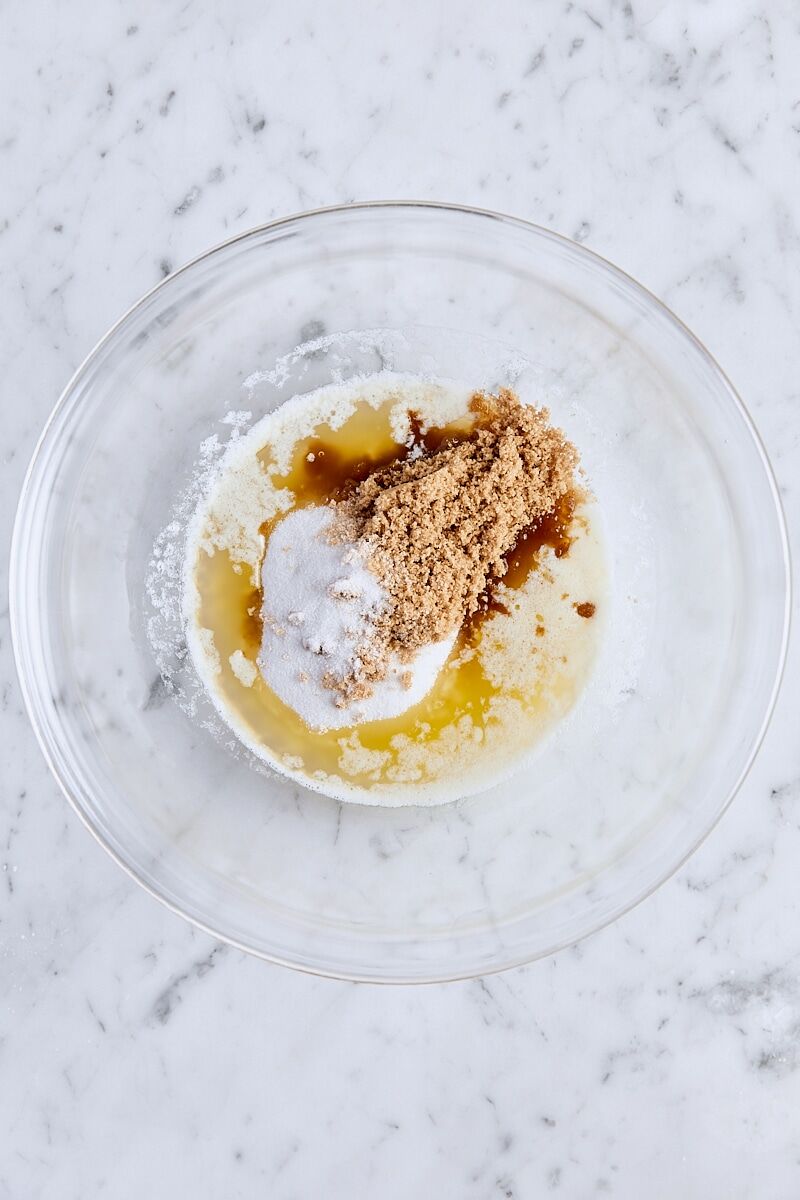 Melted butter, granulated sugar, and light brown sugar in medium glass bowl