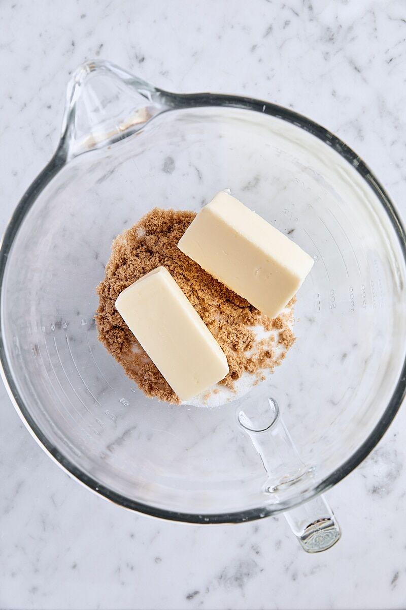 Room temperature butter, granulated sugar, and light brown sugar in glass mixer bowl