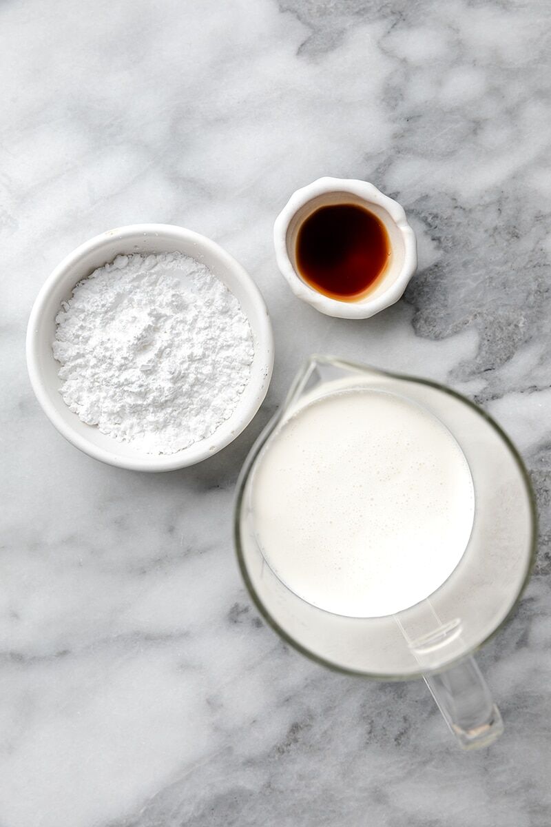 Chilled heavy cream, powdered sugar, and vanilla extract