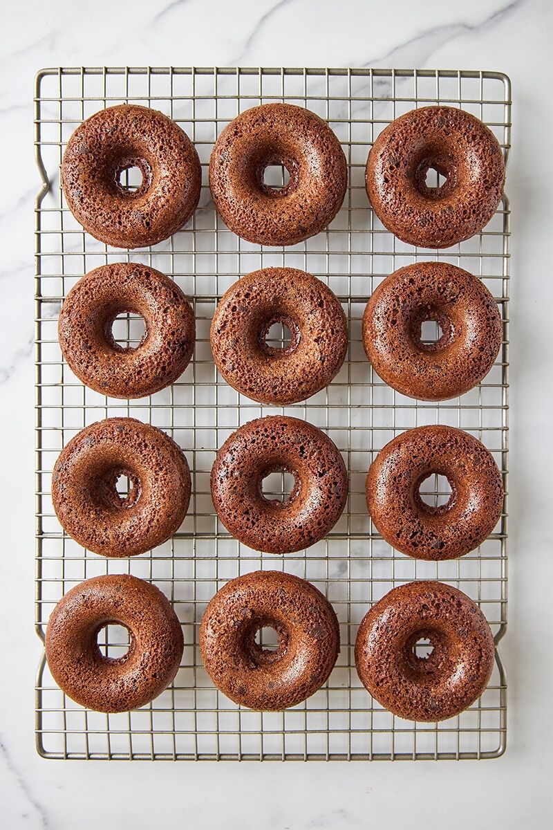 Baked chocolate donuts on cooling rack