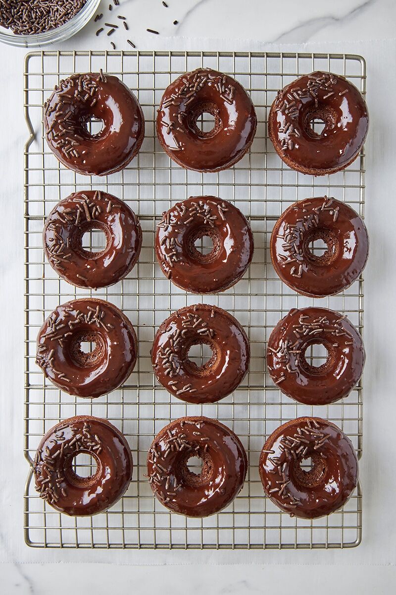 Chocolate donuts topped with chocolate glaze and chocolate sprinkles