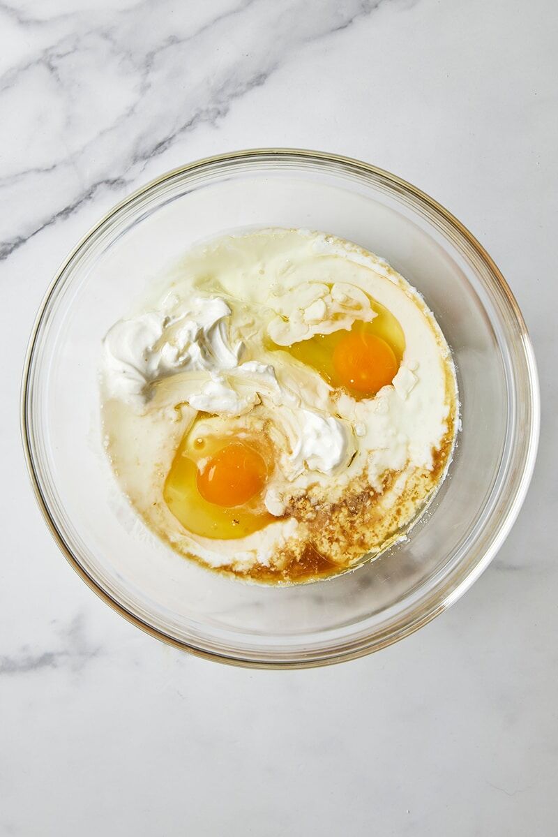 Buttermilk, sour cream, eggs, oil, and vanilla in glass bowl