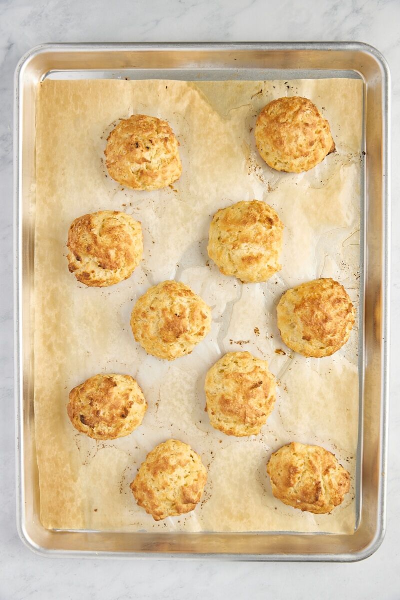 Baked biscuits on parchment-lined baking sheet