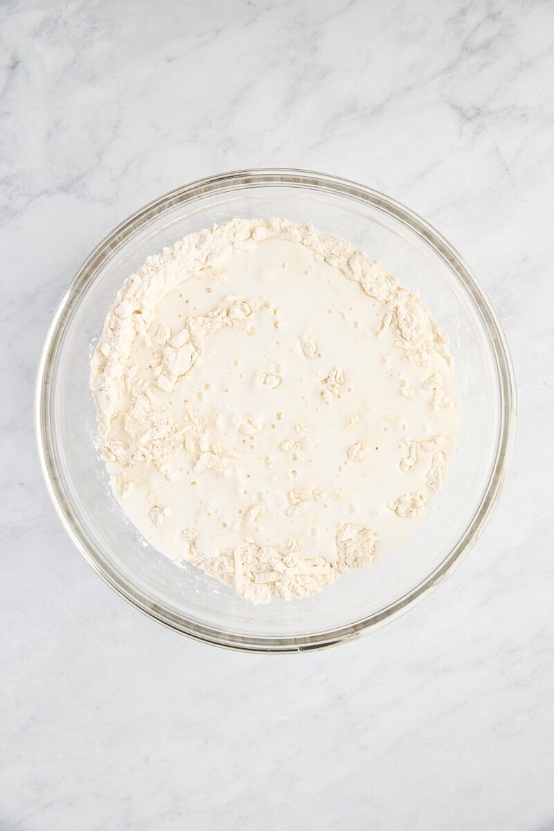 Buttermilk drizzled over flour mixture