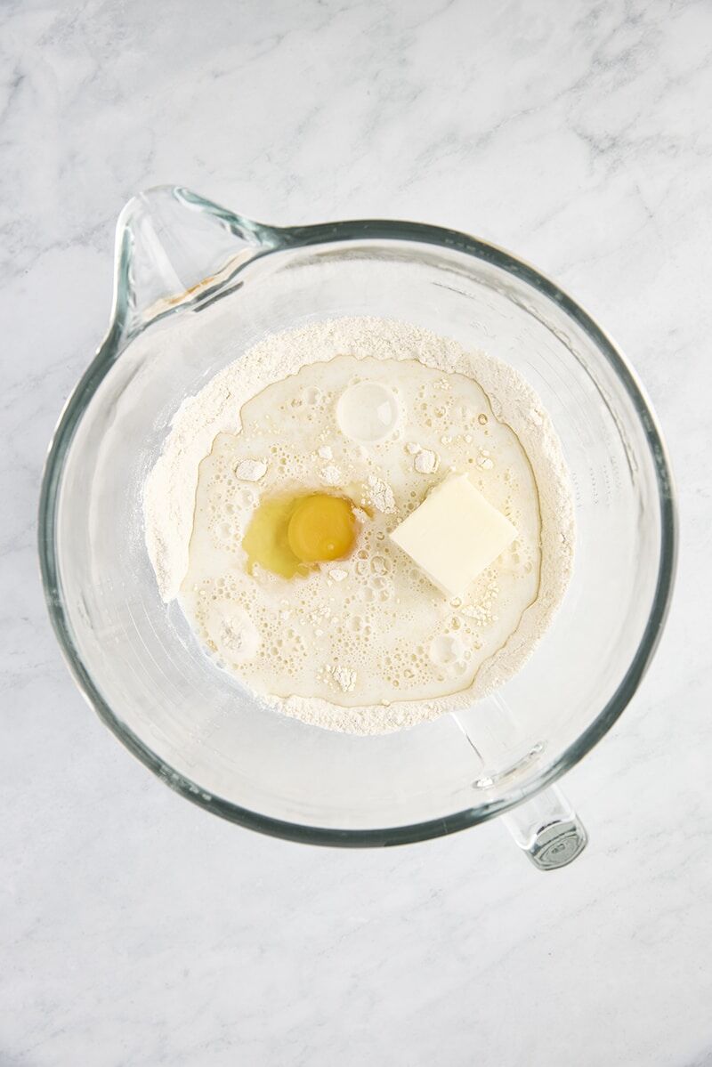 Warm milk, butter, and egg added to dry ingredients in glass mixer bowl