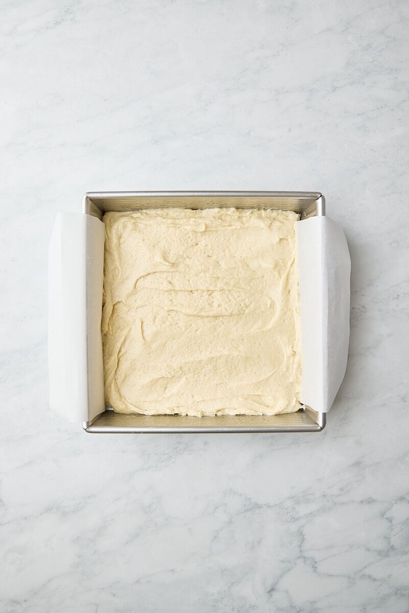 Crumb cake batter in parchment-lined square pan